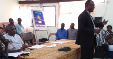 The District Assembly Procurement Officer addressing community representatives, Volta Region